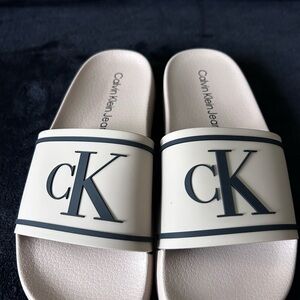 Calvin Klein Jeans Cream Slide Sandals with Black CK Logo